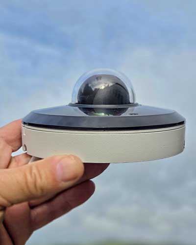 A Dahua mini PTZ camera held in the hand