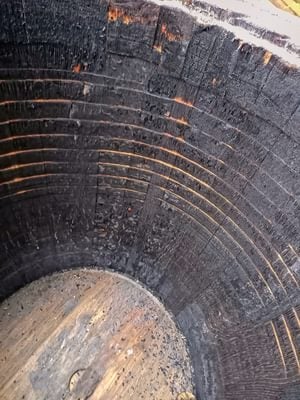 The blackened, charred inside of an old whisky barrel
