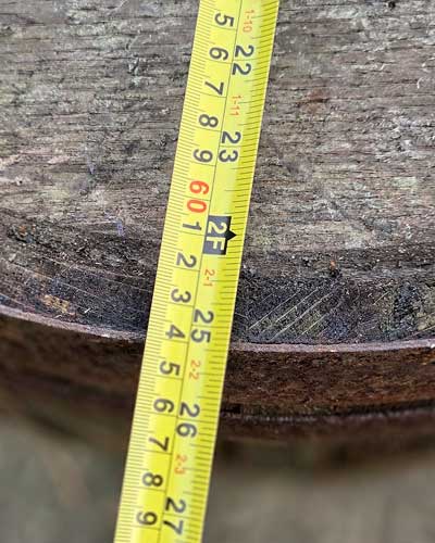 Tape measure across the base of an old oak whisky barrel